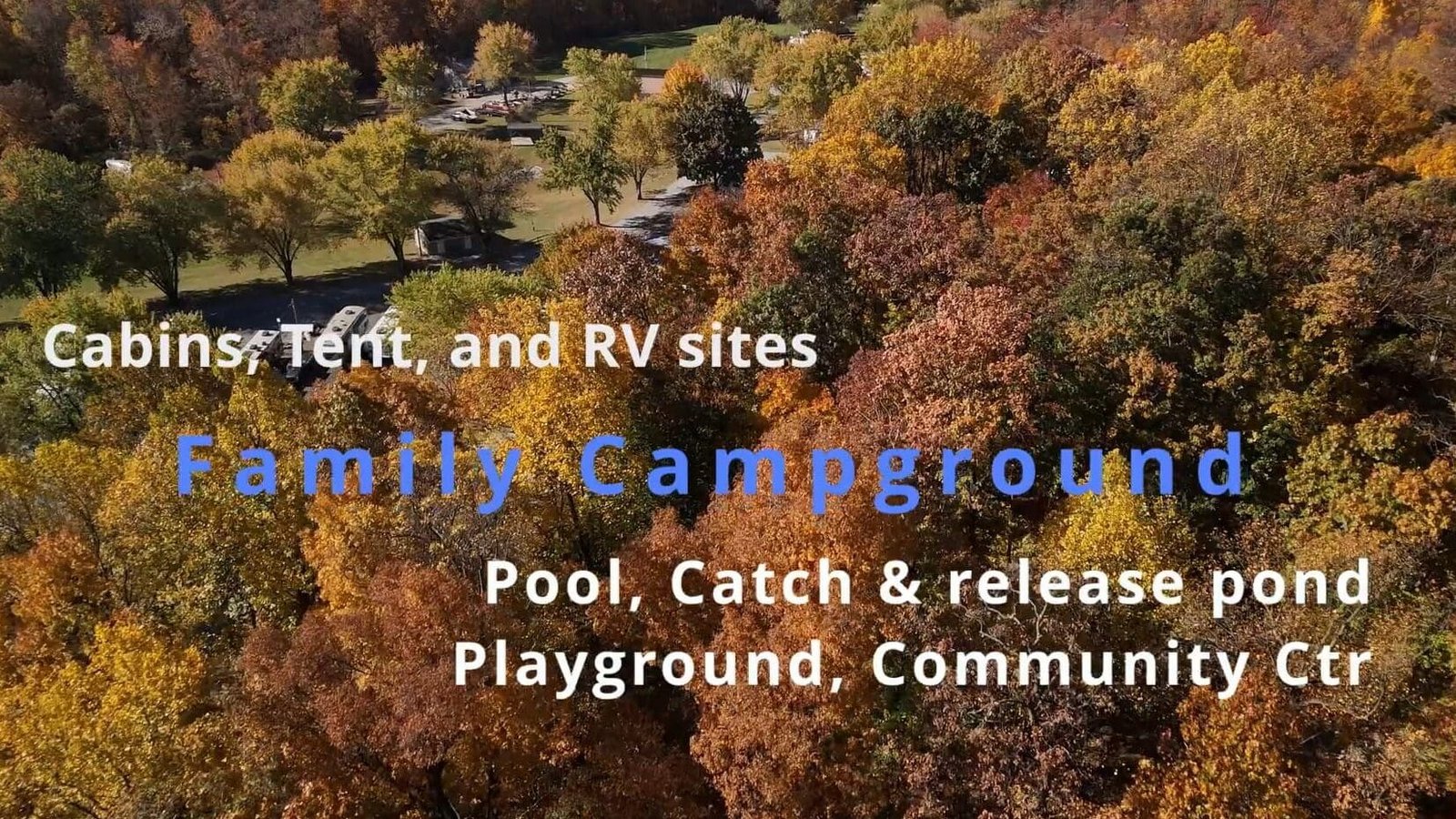 Fall colored trees with a road and vehicles toward the background and the text "Canins, Tent, and RV sites; Fanily Campground; Pool, Catch & release pond; Playground, Community Ctr" on the picture.